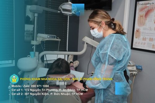 Bệnh nhân đang chăm sóc vết khâu bằng chỉ tự tiêu sau khi nhổ răng khôn tại nhà, tuân thủ hướng dẫn vệ sinh của bác sĩ